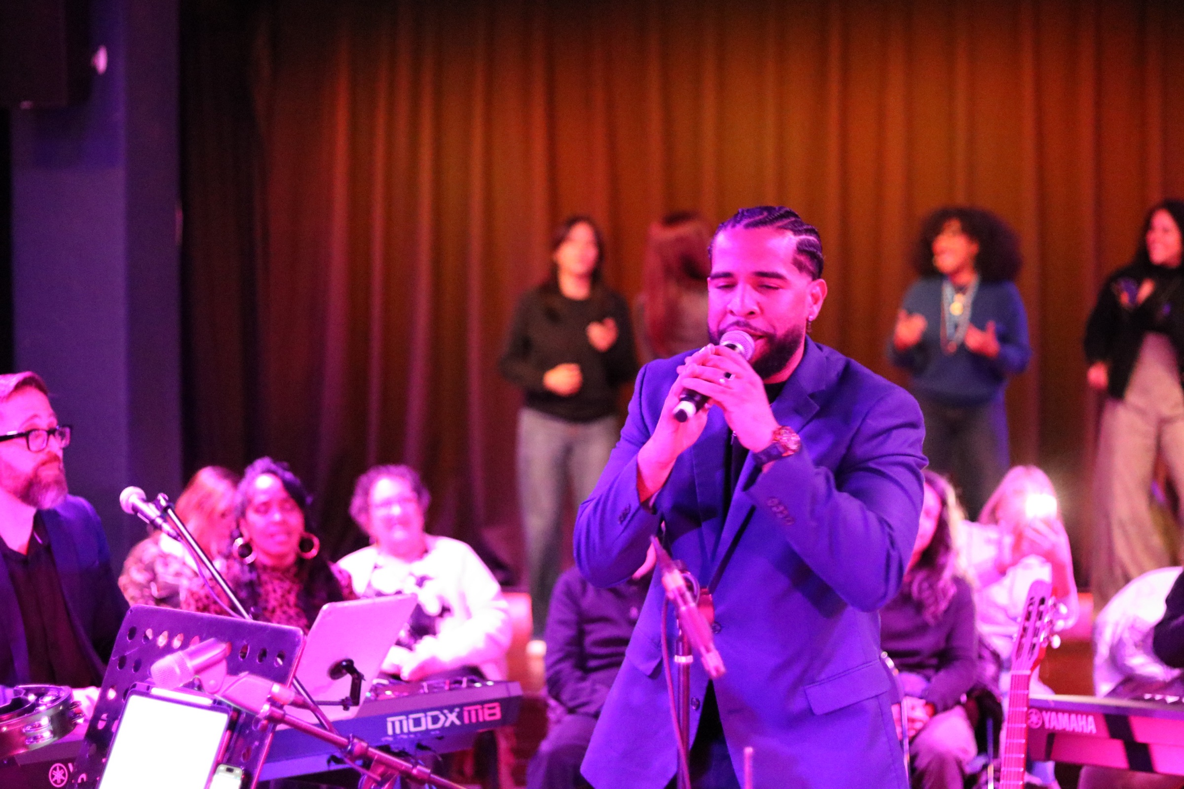 An artist singing during a live community concert